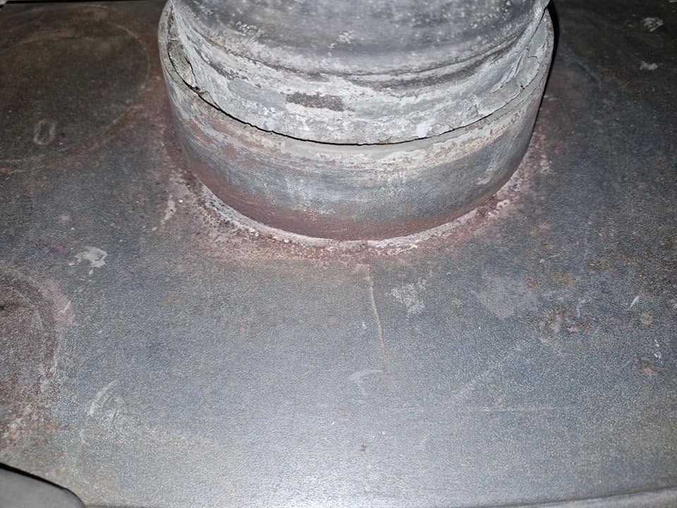 The top of a stove where the flue pipe meets it