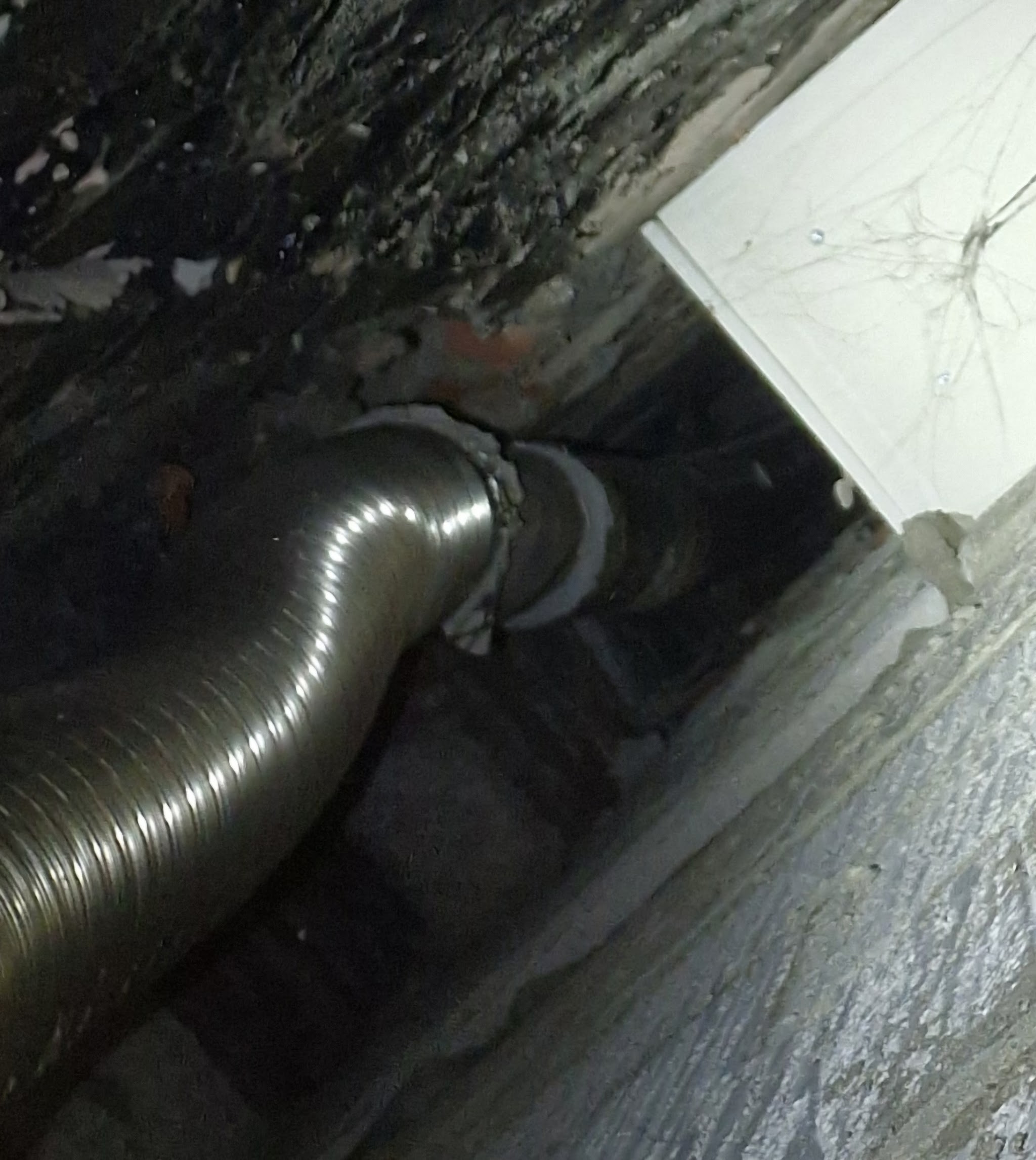 A flexible steel flue liner inside a chimney void